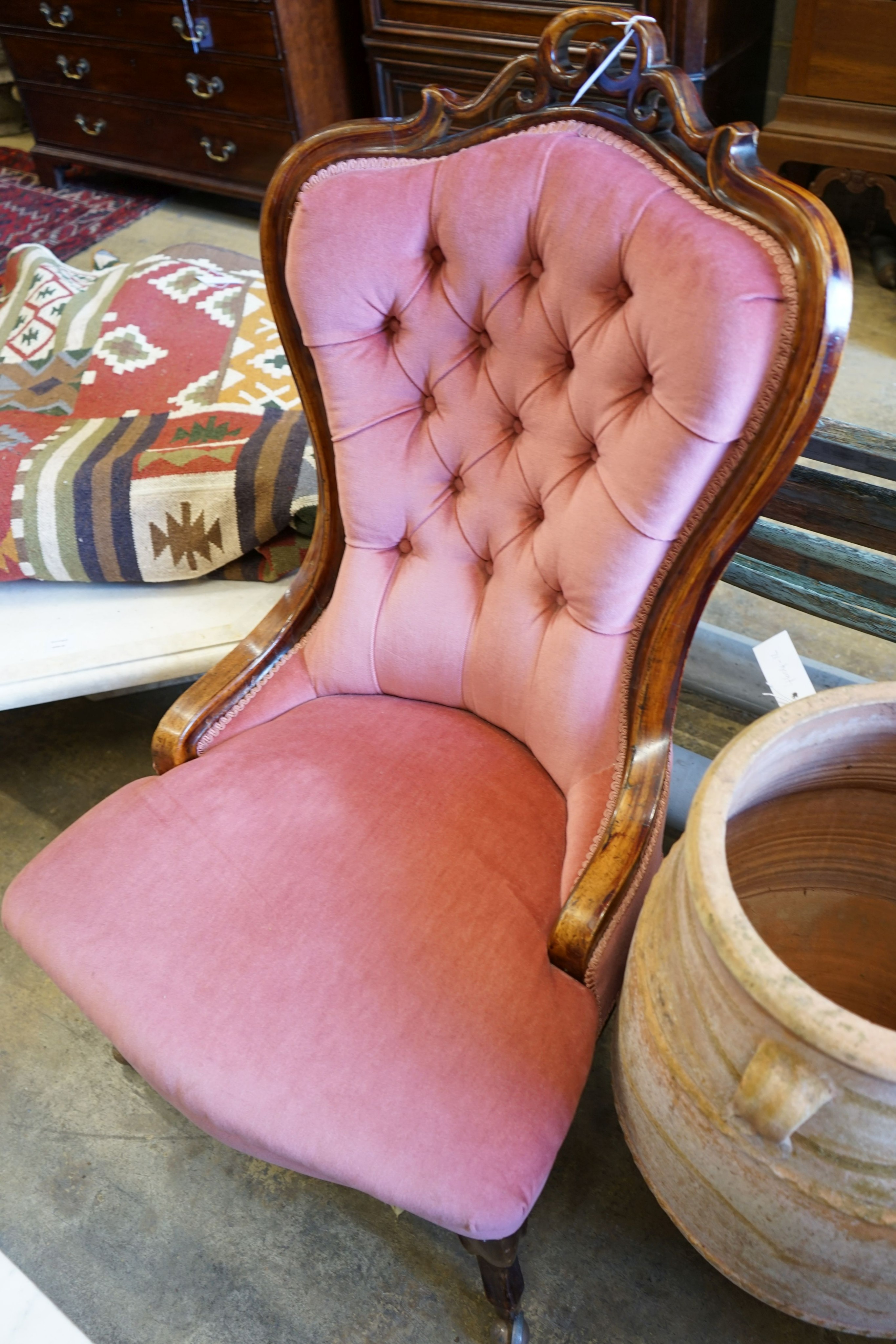 A 19th century Hungarian carved walnut upholstered spoonback nursing chair